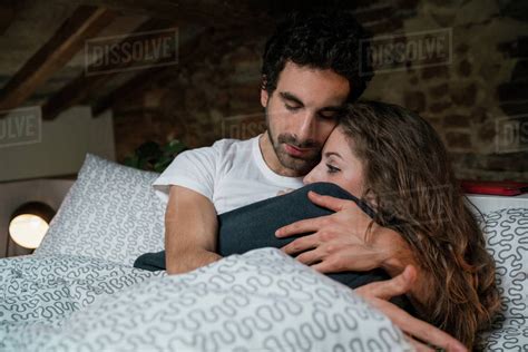 couple hugging bed